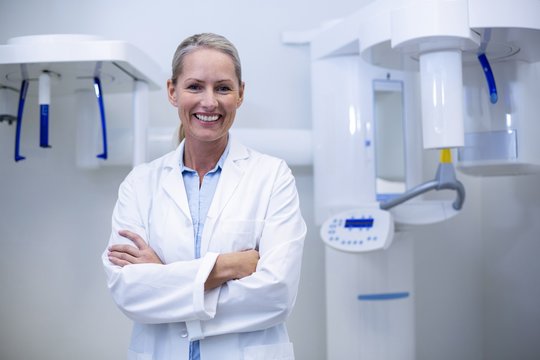 Portrait Of Female Dentist Smiling With Arms Crossed