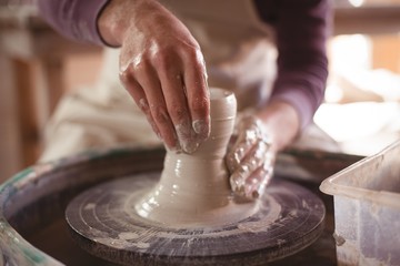 Male potter making pot
