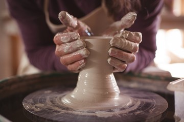 Male potter making pot