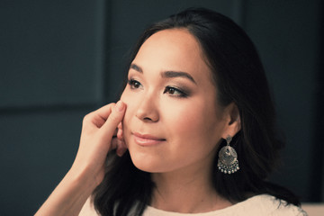 Young asian woman. clean skin resting after skincare, on dark background. beautiful Spa Perfect Fresh face