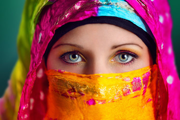 Beautiful Arabic woman wearing colorful hijab.