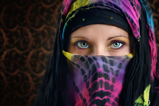 Close up of young Arabic woman colorful eyes.