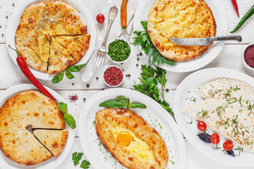 Bakery products - georgian national cuisine. Hachapuri, cheburek lavash, meat pies, served on white background