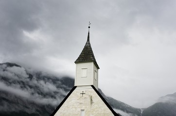 Eidfjord Church Norway on a Cloudy day with hills in background