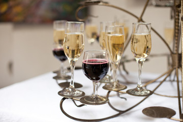 Different kinds of glasses with alcohol stand on the original ho