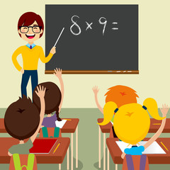 Happy young male teacher standing asking maths lesson to children raising hands up sitting in classroom