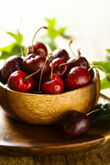 Fresh cherries in wooden bowl