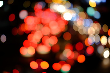 Colorful defocused bokeh lights background. Festive background with natural bokeh. Abstract blur background.