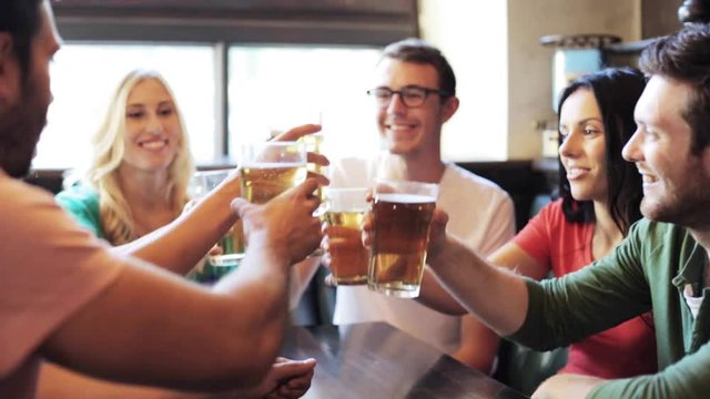 happy friends drinking beer at bar or pub