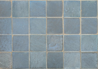 the old, dirty, alkali, rust dark blue and gray, color of blue tone chipped wall tiles of the building background texture