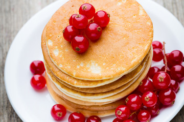 Stack of pancakes with blueberry and fresh berry.