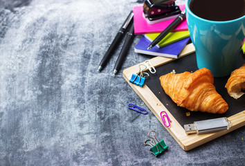 School business stationery croissants mug of coffee on grunge chalkboard