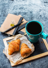 Business stationery croissants mug of coffee on grunge chalkboard
