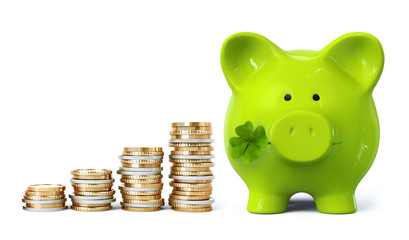 Green piggy bank with four leaf clover and coin stacks in ascending order