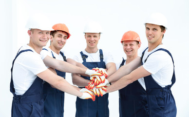 Team of builders joining hands in circle