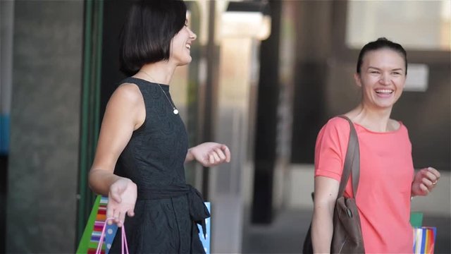 Girls leaving shopping mall after a successful shopping