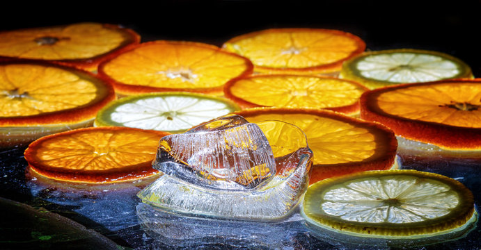 transparent slices of oranges and lemons on the glass
