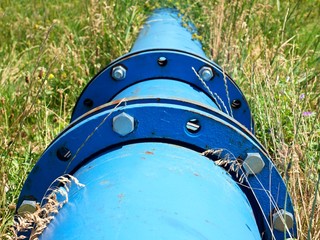 Repaired  water pipes with blue flanges and screws