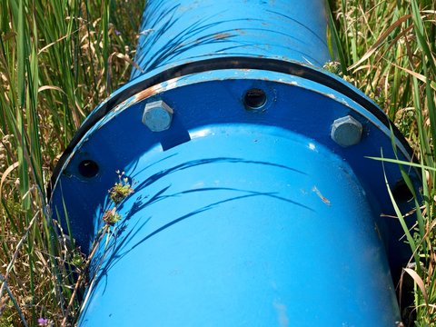 Repaired  water pipes with blue flanges and screws