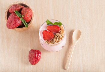 Strawberry yogurt with fresh strawberries and muesli.