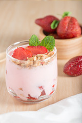 Healthy Strawberry yogurt with fresh strawberries and muesli.