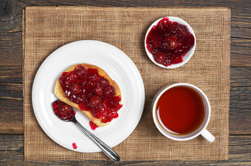 Tea and cherry jam with bread