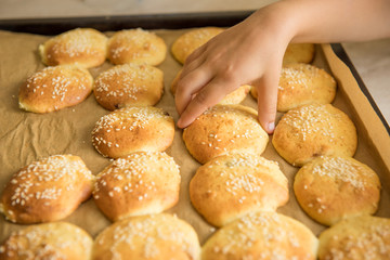 Homemade cookies on dripping pan. Hand takes
