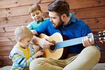 Playing guitar with father