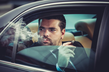 Dangerous man in the car smoking