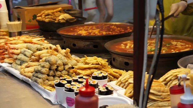 Seoul, Korea variety of Korean street food stall, tteokbokki, fish hotdog, sausage and other fried food on stick