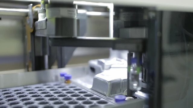 Modern science laboratory with test tubes and robotic tools or equipment. 