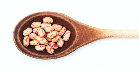 Pinto beans in a wooden spoon