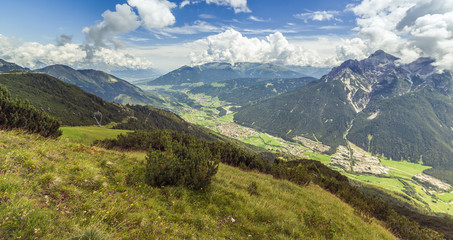 Fototapeta premium Mountain landscape with trail, green meadow and forest