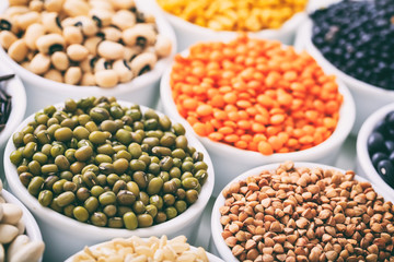 Various raw legumes and rice in bowls