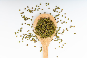 Raw green beans in a wooden spoon