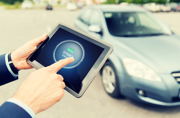 close up of hands with car starter on tablet pc