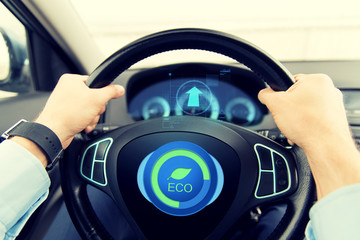 close up of young man driving car in eco mode