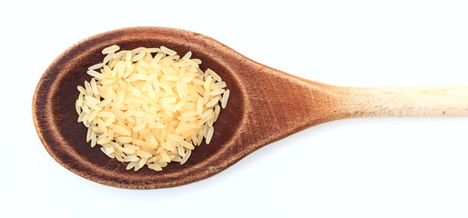 Raw parboiled rice in a wooden spoon