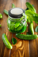 pickled cucumbers with spices in glass jar