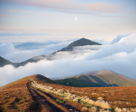Fototapeta Mountain landscape with road and beautiful fog