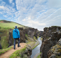 Tourist standing on the top of the canyon in Iceland