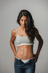 Obraz premium Strong long haired woman in jeans looks down