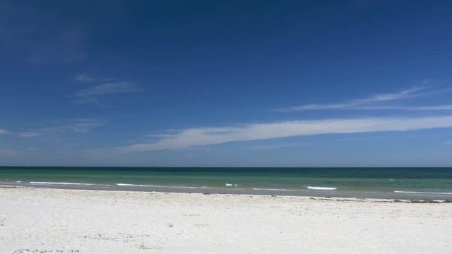 Beach scene without people. Peaceful and relaxing. White sand and blue sky. Clip contains beach, water, background, calm sea, smooth water, peaceful, relaxing, beautiful, blue, white