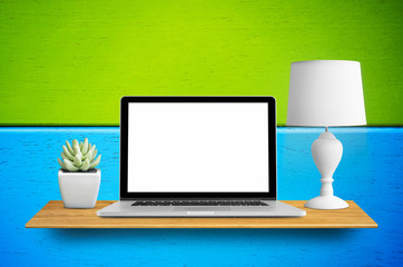 Laptop on bookshelf.