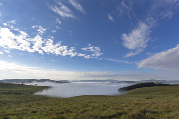 Fototapeta na wymiar Clouds in the sky and fog on the ground