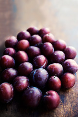 Fresh plums on a dark wood background. Top view image. .Ripe Plu