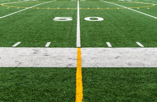 Football field at fifty 50 yard line. Abstract image of sports football field at half field line. Sports field. 