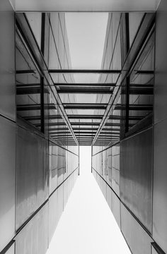 Urban Geometry, looking up to glass building. Modern architecture, glass and steel. Abstract architectural design. Inspirational, artistic image. Industrial design. .Modern building. Black and white.