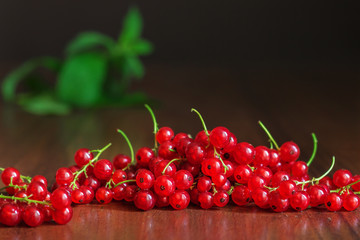Close up with red currants berries on wooden table