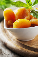 Sweet dried apricots and mint on the wooden table